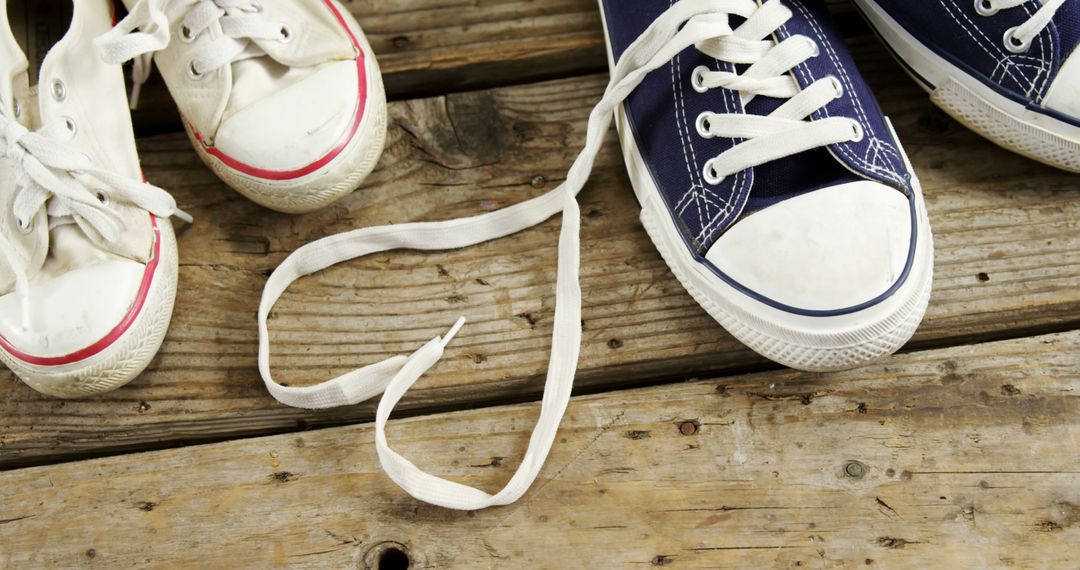 Close-up of Sneakers with Shoe Lace Forming Heart Shape on Wooden Background - Free Images, Stock Photos and Pictures on Pikwizard.com