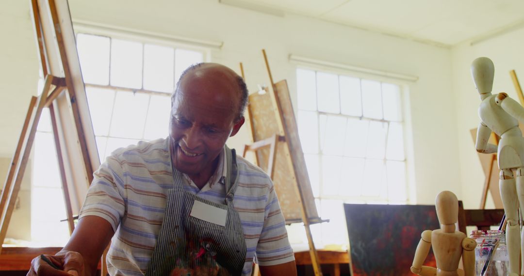 Senior African American Man Painting in Art Studio - Free Images, Stock Photos and Pictures on Pikwizard.com