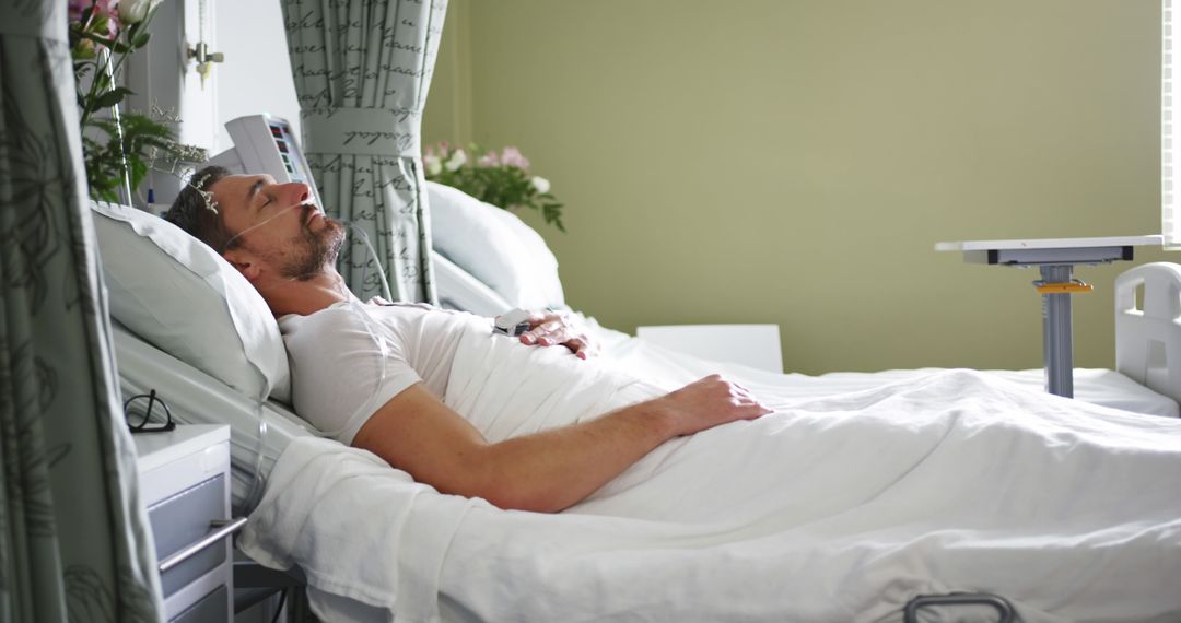 Man Resting in Hospital Bed with Medical Equipment - Free Images, Stock Photos and Pictures on Pikwizard.com