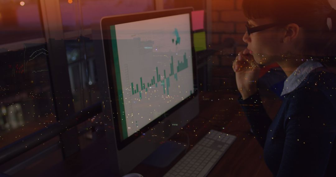 Businesswoman Analyzing Data on Computer Over Urban Night Scene