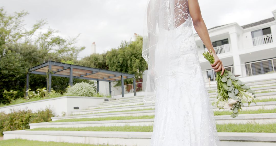 Beautiful Bride in White Wedding Dress Walking Outside Mansion - Free Images, Stock Photos and Pictures on Pikwizard.com