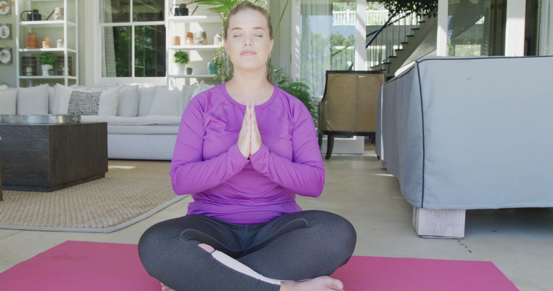 Woman Meditating in Lotus Position Indoors - Free Images, Stock Photos and Pictures on Pikwizard.com