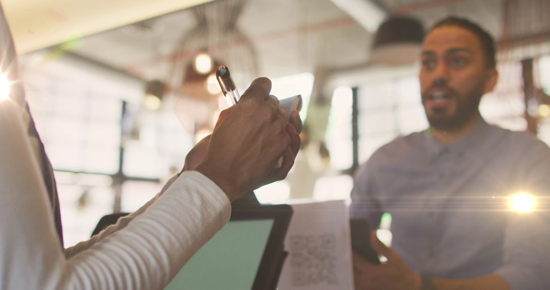 Customer Using Digital Payment Method at Cafe Counter