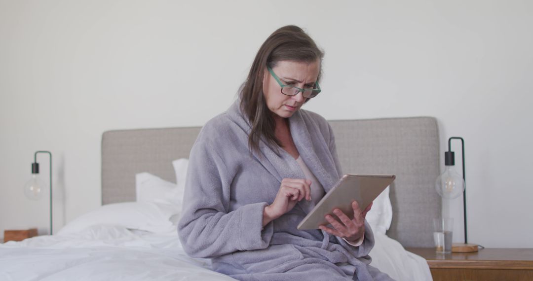 Mature Woman Using Digital Tablet in Bed, Morning Routine - Free Images, Stock Photos and Pictures on Pikwizard.com