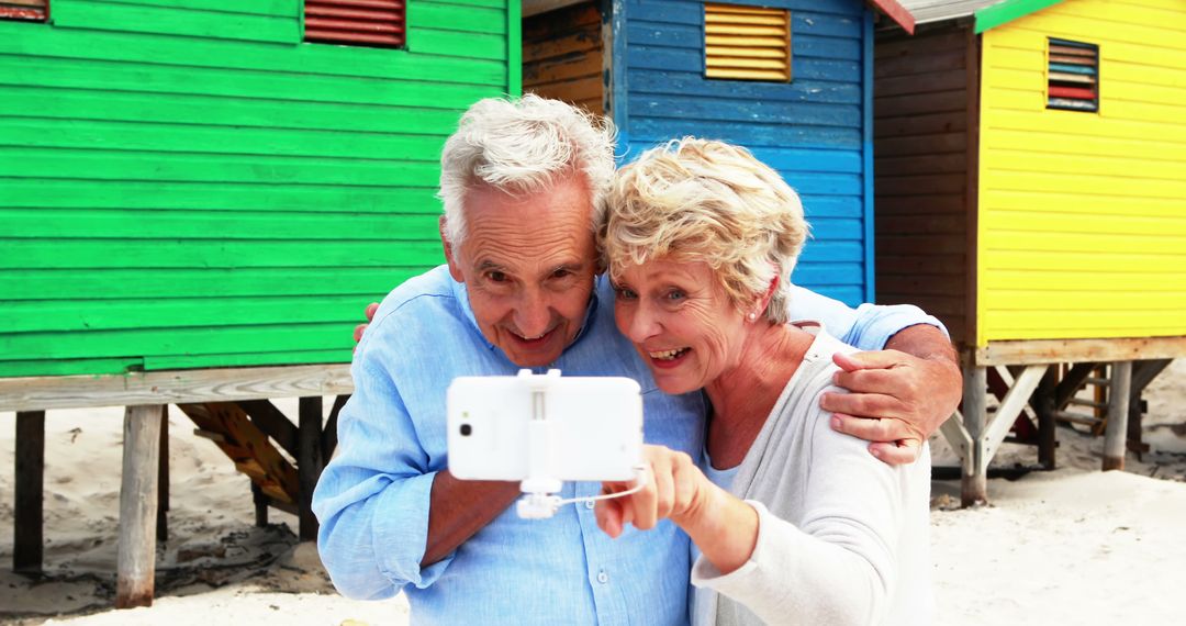 Senior Couple Taking Selfie at Colorful Beach Houses - Free Images, Stock Photos and Pictures on Pikwizard.com