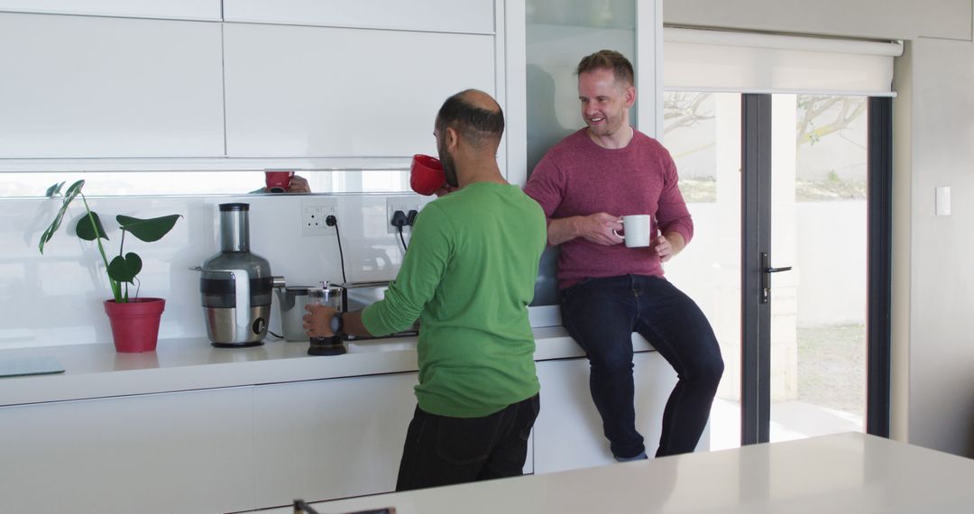 Friends Conversing in Modern Kitchen with Coffee Cups - Free Images, Stock Photos and Pictures on Pikwizard.com