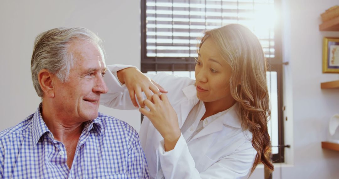 Healthcare Professional Assisting Elderly Patient at Clinic - Free Images, Stock Photos and Pictures on Pikwizard.com