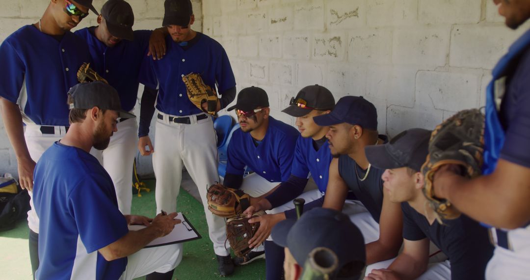 Baseball Coach Guiding Diverse Team in Dugout - Free Images, Stock Photos and Pictures on Pikwizard.com