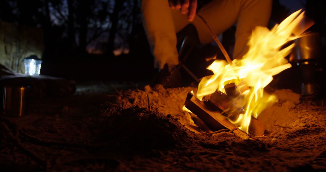 Person Tending Campfire in Night Forest - Free Images, Stock Photos and Pictures on Pikwizard.com