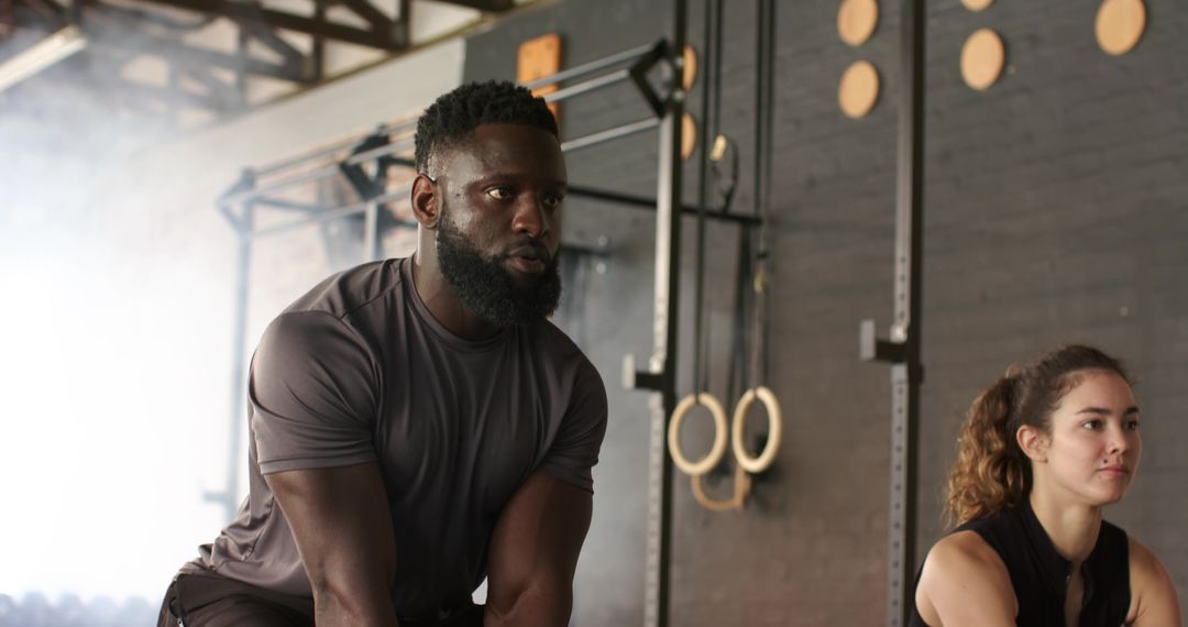 Diverse Fitness Enthusiasts Performing Strength Exercises at Gym