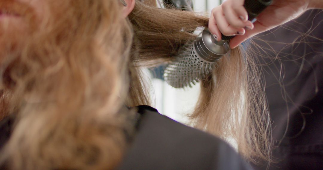 Close-up of Hairdresser Brushing Long Hair in Salon - Free Images, Stock Photos and Pictures on Pikwizard.com