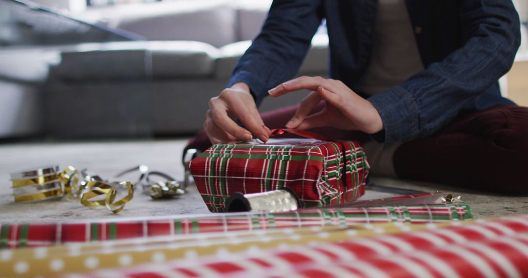 Hands Wrapping Christmas Gift with Red Plaid Paper - Free Images, Stock Photos and Pictures on Pikwizard.com