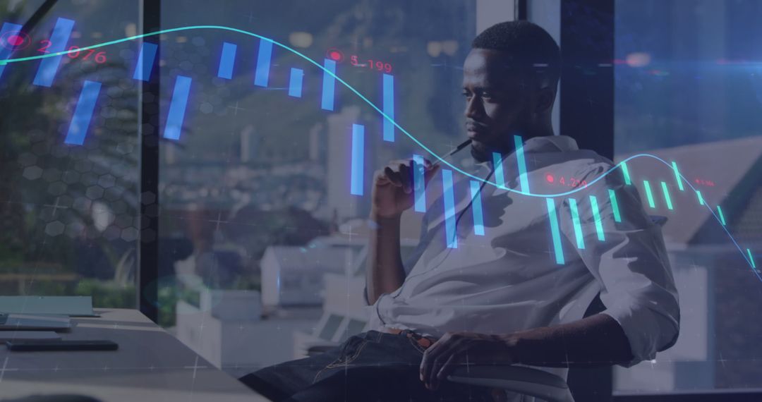 Focused Professional Analyzing Financial Data with Stock Market Graph Overlay - Free Images, Stock Photos and Pictures on Pikwizard.com