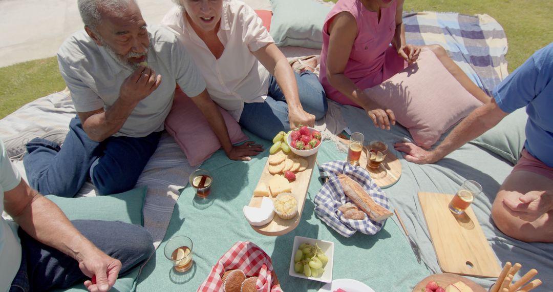 Family and Friends Enjoying an Outdoor Picnic with Fresh Snacks - Free Images, Stock Photos and Pictures on Pikwizard.com