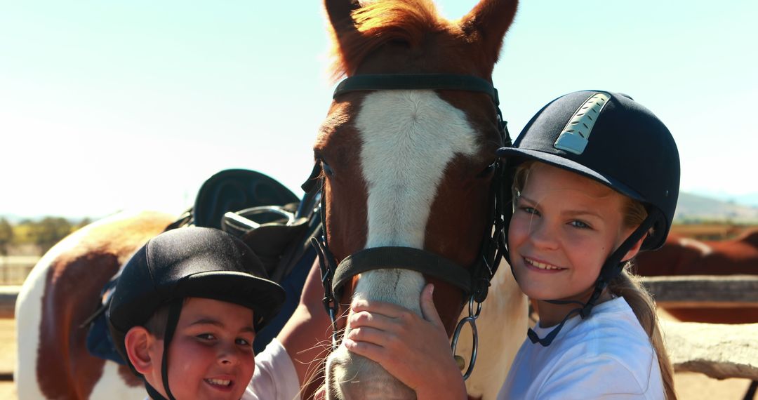 Happy Children Bonding with Horse in Equestrian Gear Outdoors - Free Images, Stock Photos and Pictures on Pikwizard.com