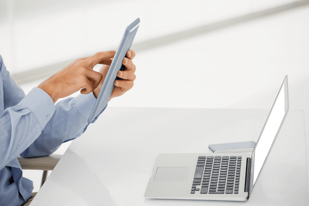 Businessman Interacting with Transparent Digital Tablet at Desk
