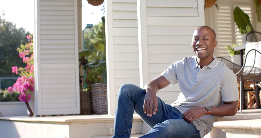 Smiling Man Relaxing on Porch in Sunlight