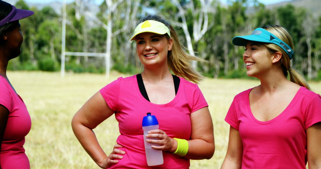 Group of women smiling after outdoor exercise in pink shirts - Free Images, Stock Photos and Pictures on Pikwizard.com