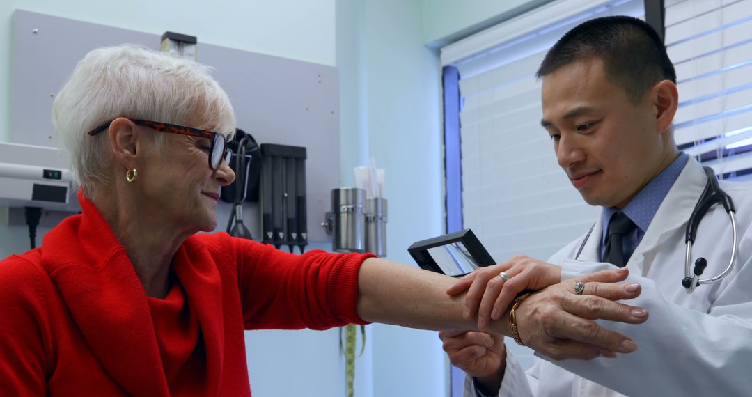 Doctor Examining Patient's Arm in Medical Office - Free Images, Stock Photos and Pictures on Pikwizard.com