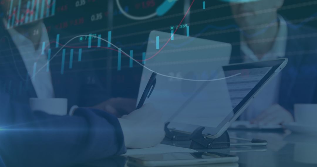 Coworkers Discussing Financial Reports with Digital Chart Overlay