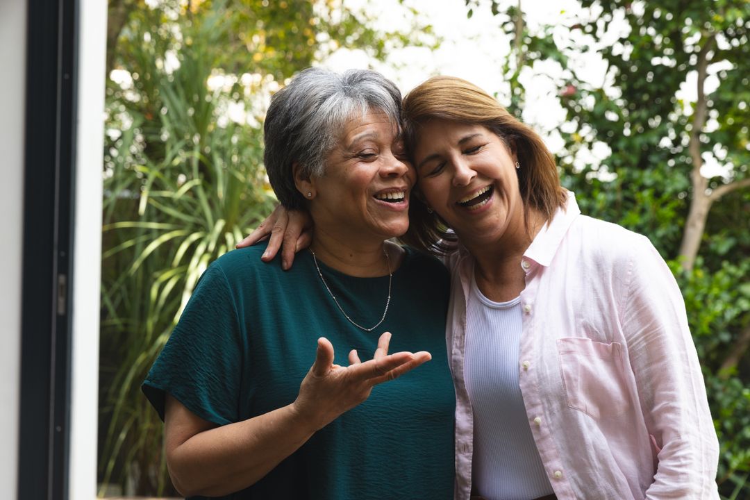 Elderly Mother and Daughter Laughing Together in Garden