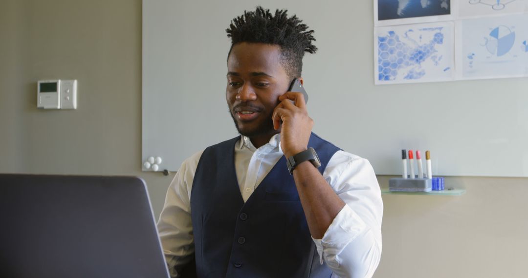 Confident African American Businessman Working on Laptop and Smartphone in Office - Free Images, Stock Photos and Pictures on Pikwizard.com