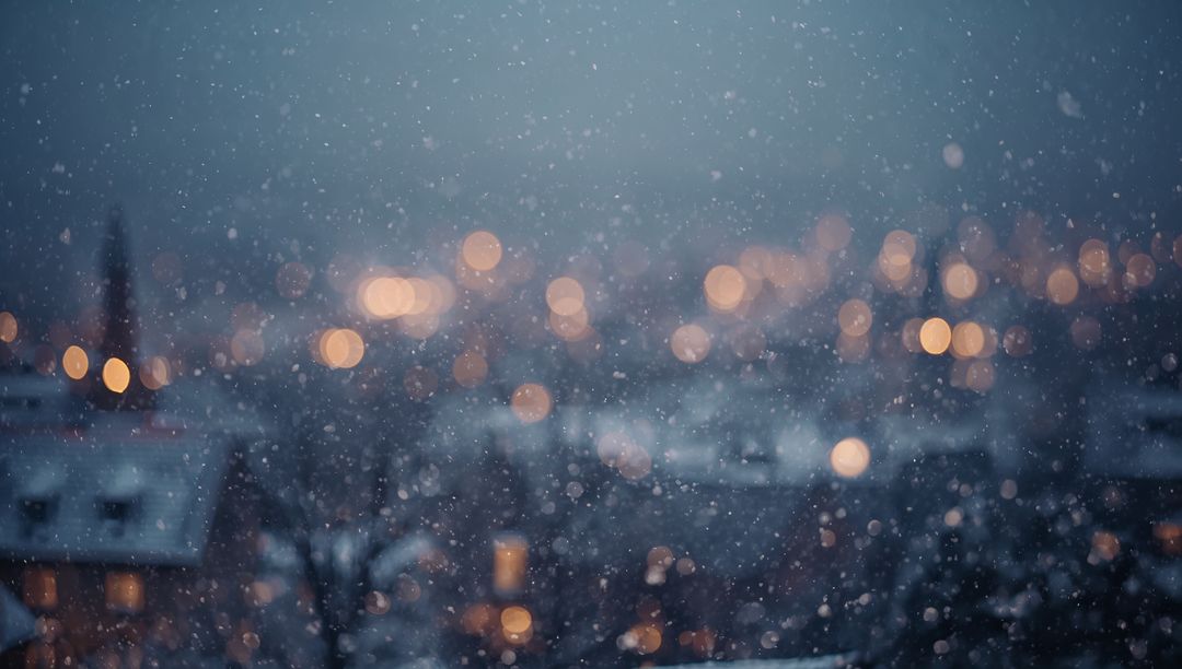 Snowflakes Drifting Over Snowy Rooftops With Warm Amber Bokeh Lights at Urban Dusk