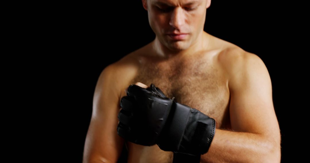 Male Boxer Wrapping Hands with Black Straps in Dark Background - Free Images, Stock Photos and Pictures on Pikwizard.com