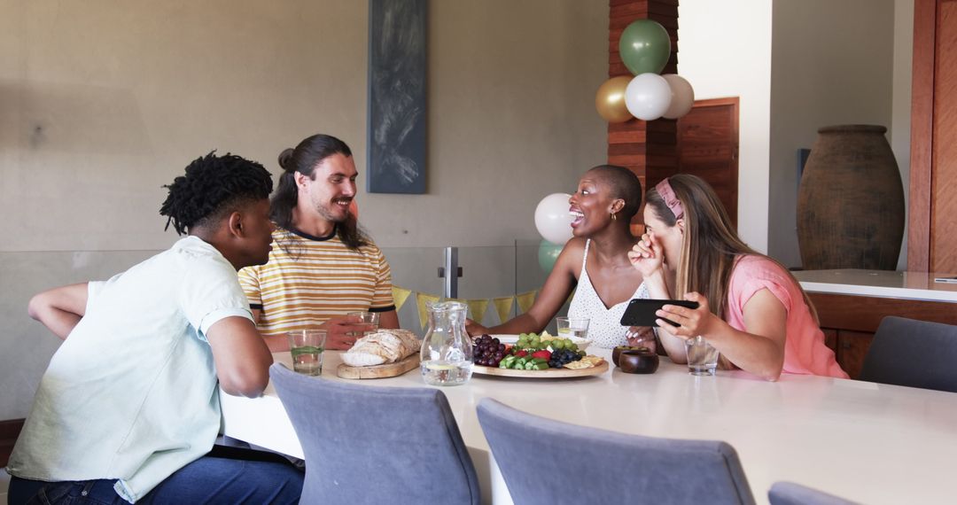 Friends Gathering and Enjoying Meal Together at Dining Table
