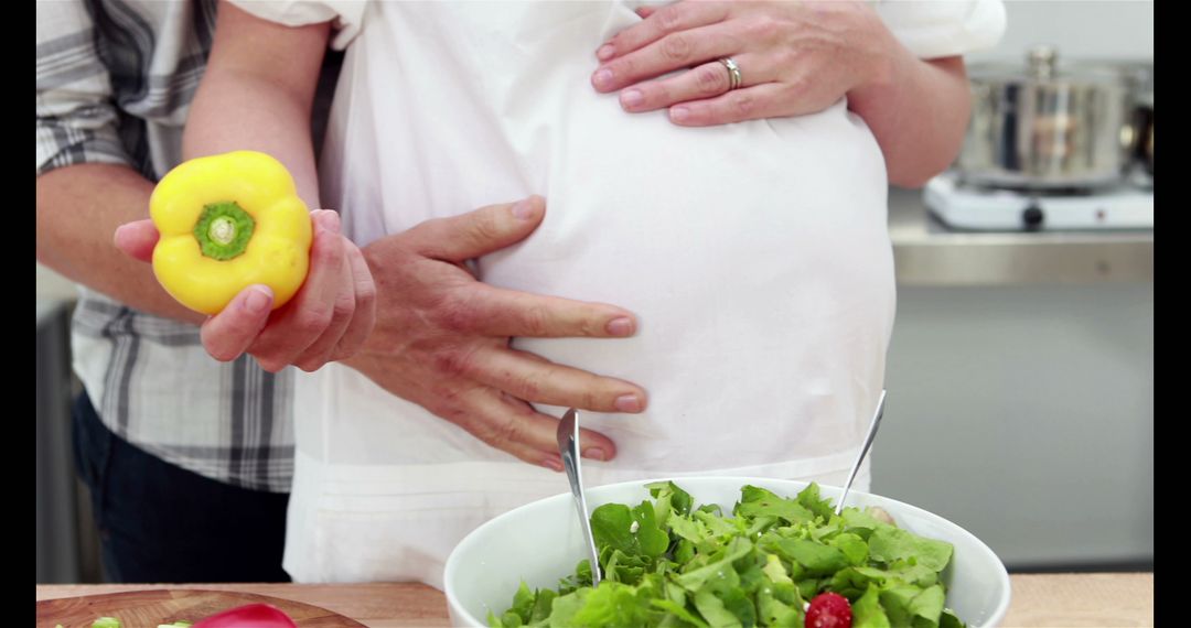 Pregnant Couple Preparing Healthy Meal in Kitchen - Free Images, Stock Photos and Pictures on Pikwizard.com