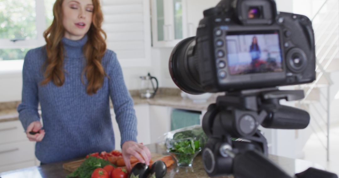 Woman filming a cooking tutorial in a modern kitchen - Free Images, Stock Photos and Pictures on Pikwizard.com