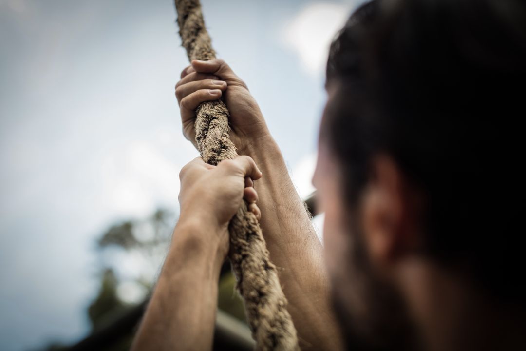 Man climbing a rope during obstacle course - Free Images, Stock Photos and Pictures on Pikwizard.com