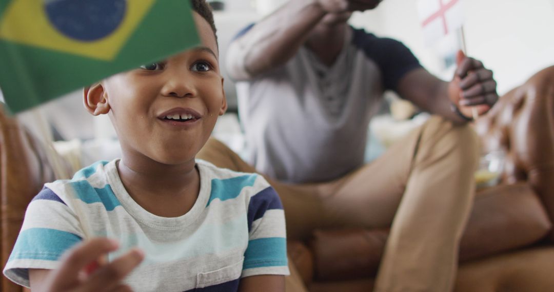 Joyful Boy Watching Soccer Match with Father