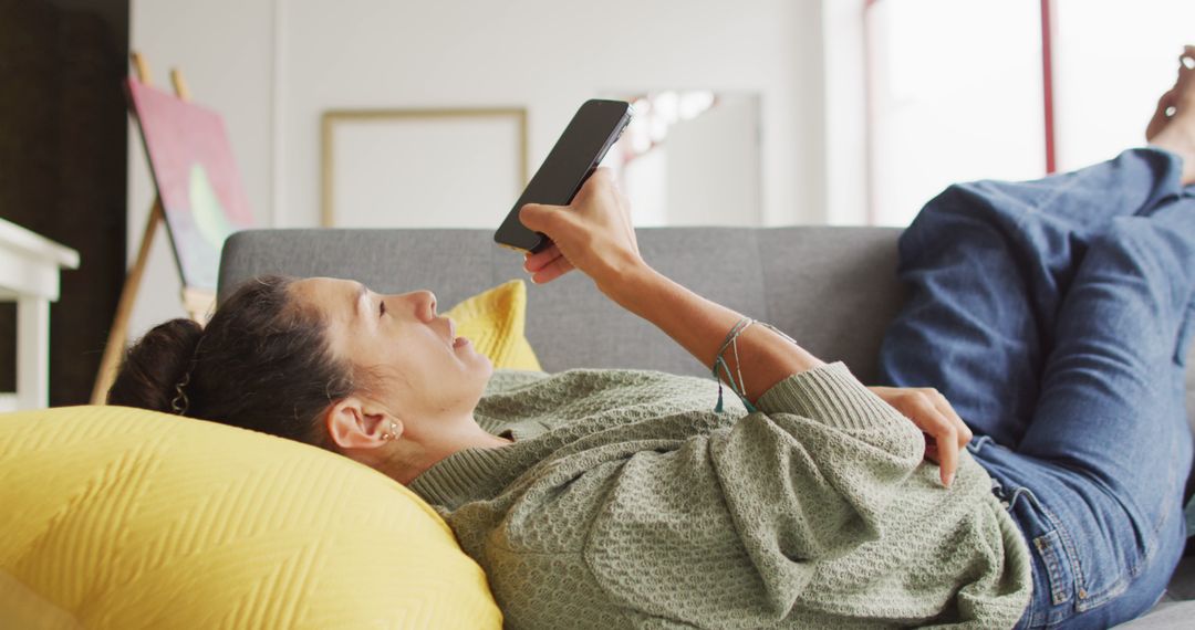 Creative Designer Relaxing with Smartphone in Studio Environment