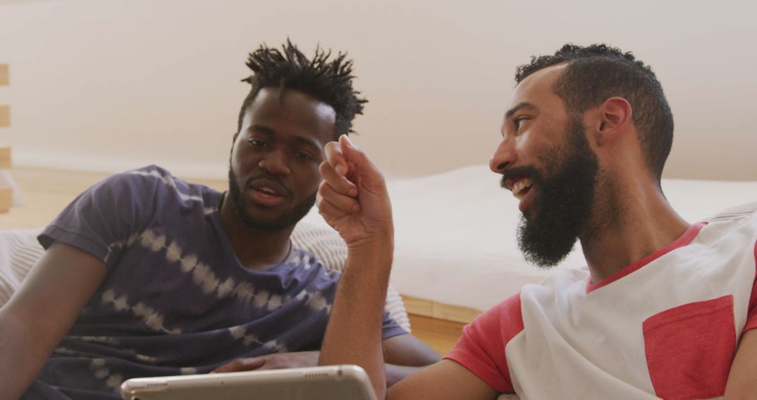 Men Relaxing on Sofa Using Tablet on Weekend