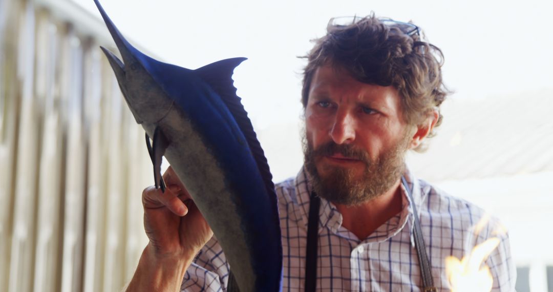 Bearded Fisherman Holding Swordfish, Displaying Proudly - Free Images, Stock Photos and Pictures on Pikwizard.com