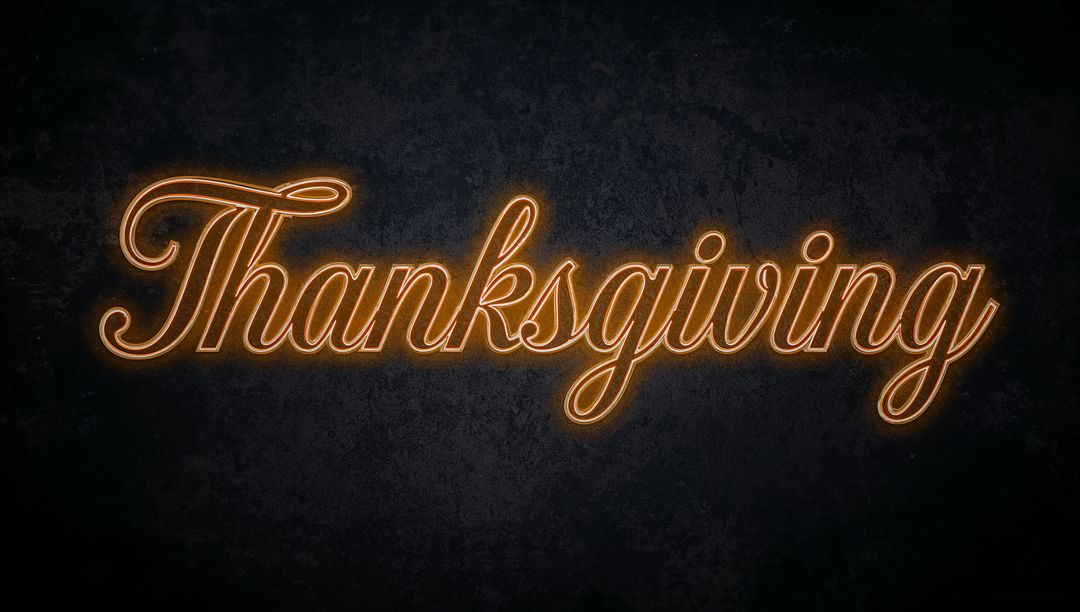 Thanksgiving Neon Script Sign Glowing Amber Cursive Typography on Dark Textured Wall
