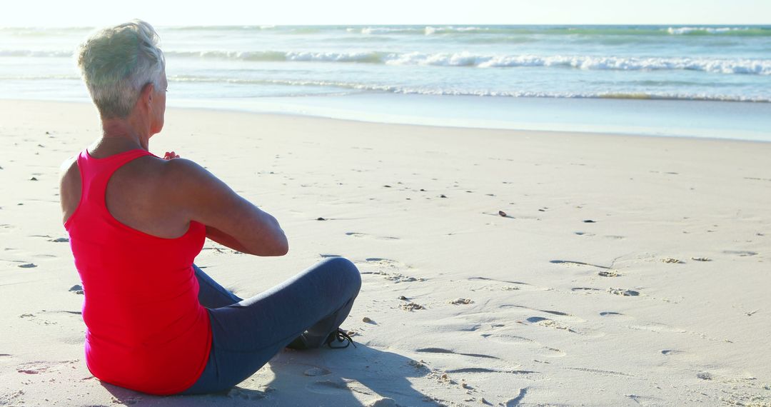 Senior Woman Meditating on Beach at Sunrise - Free Images, Stock Photos and Pictures on Pikwizard.com