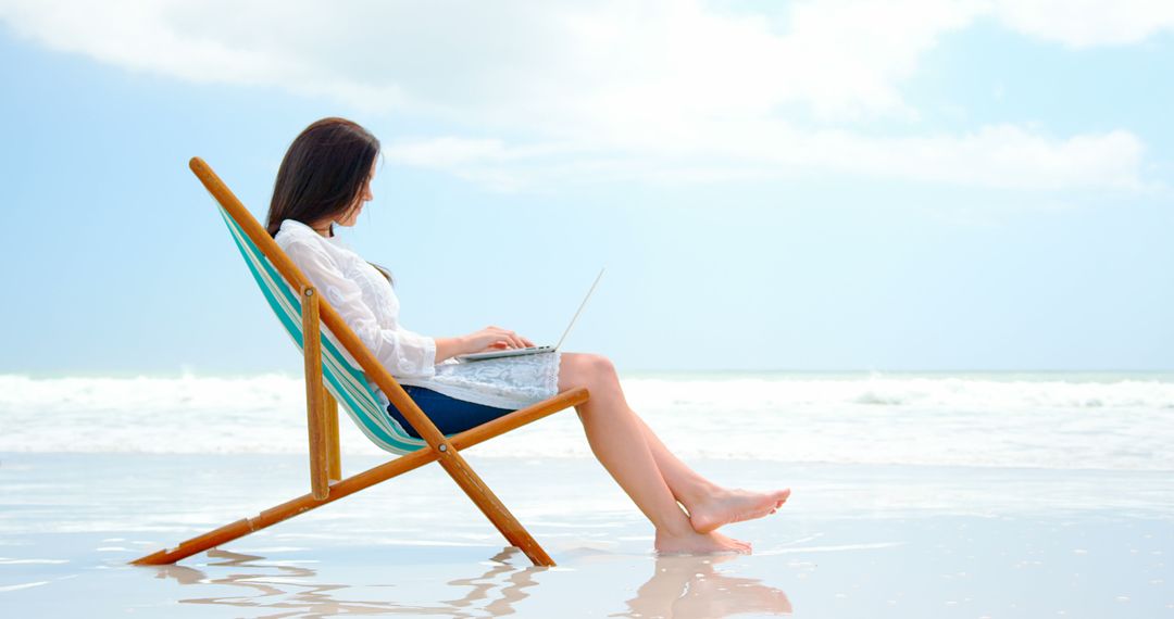 Woman Working on Laptop on Beach Recliner by Ocean - Free Images, Stock Photos and Pictures on Pikwizard.com