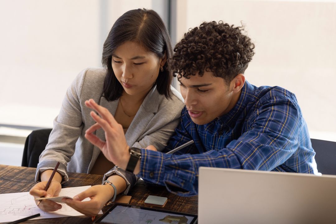 Diverse Coworkers Collaborating on Innovative Project in Modern Office