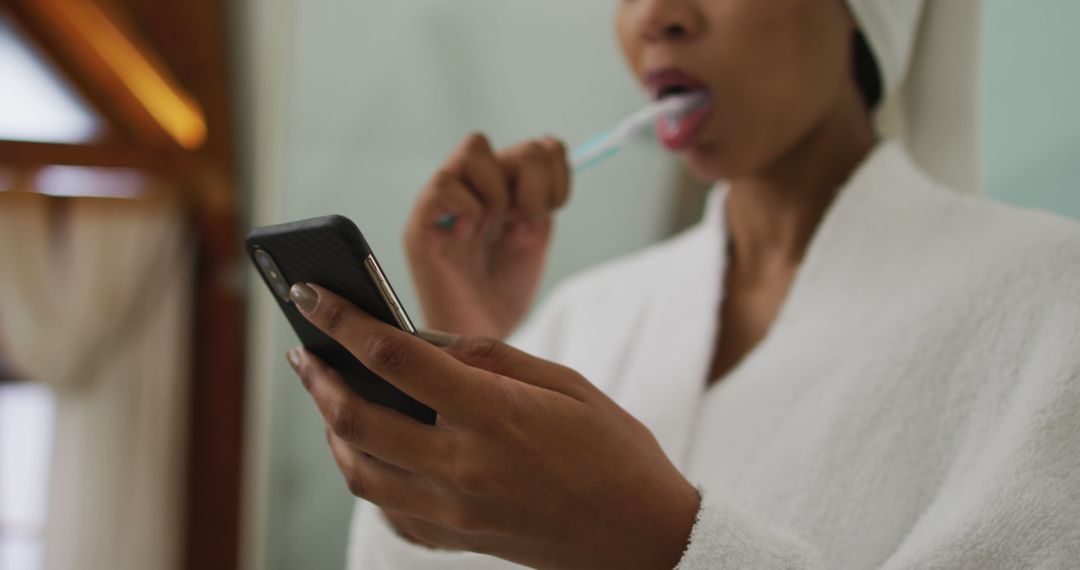 Woman Brushing Teeth Using Mobile Phone - Free Images, Stock Photos and Pictures on Pikwizard.com