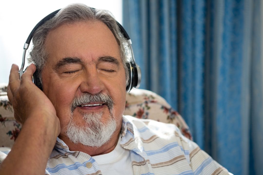Senior man listening music through headphones in nursing home - Free Images, Stock Photos and Pictures on Pikwizard.com