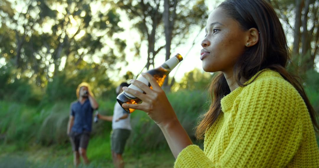 Young Woman Enjoying Outdoor Drink at Sunset - Free Images, Stock Photos and Pictures on Pikwizard.com