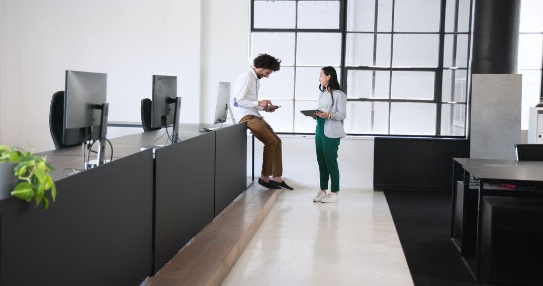 Colleagues Collaborating in Modern Workspace with Technology