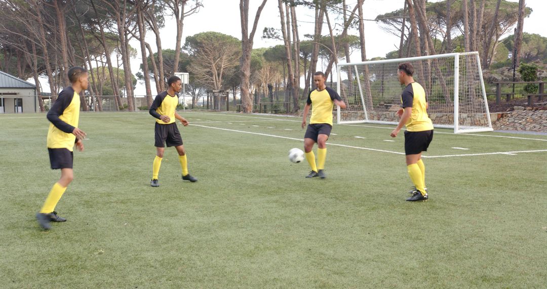 Soccer Players Practicing Passing Drills on Field in Uniforms