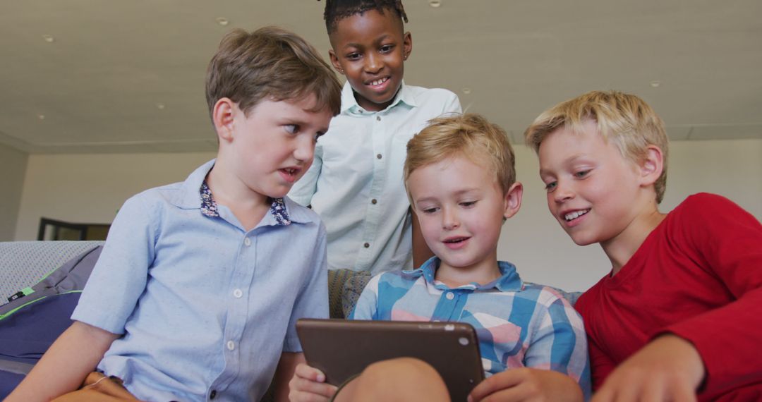 Diverse Group of Boys Enthusiastically Engaging with Tablet Technology