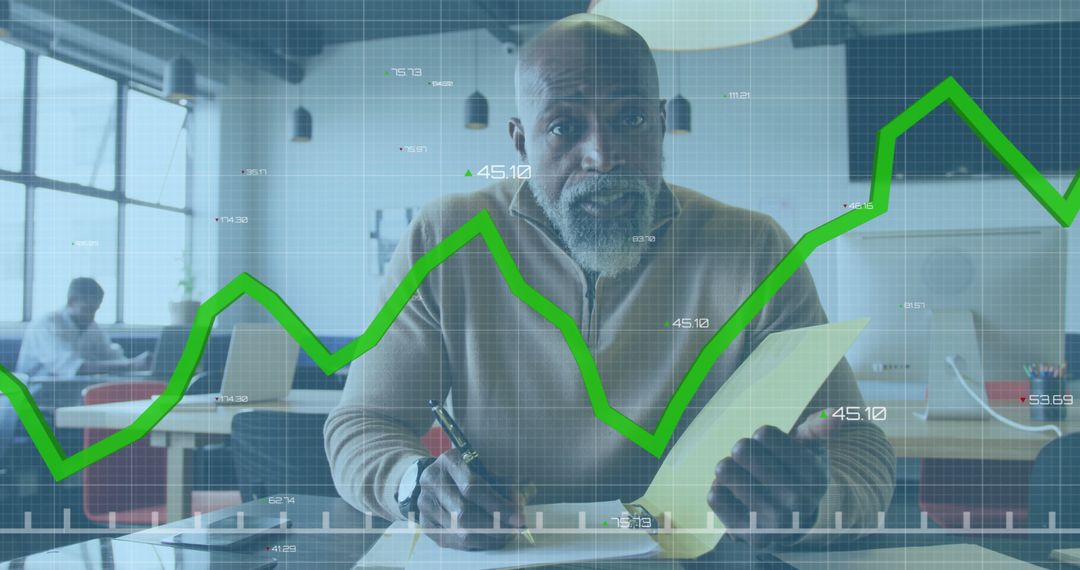 Focused Businessman Analyzing Financial Data with Green Trend Line Overlay - Free Images, Stock Photos and Pictures on Pikwizard.com