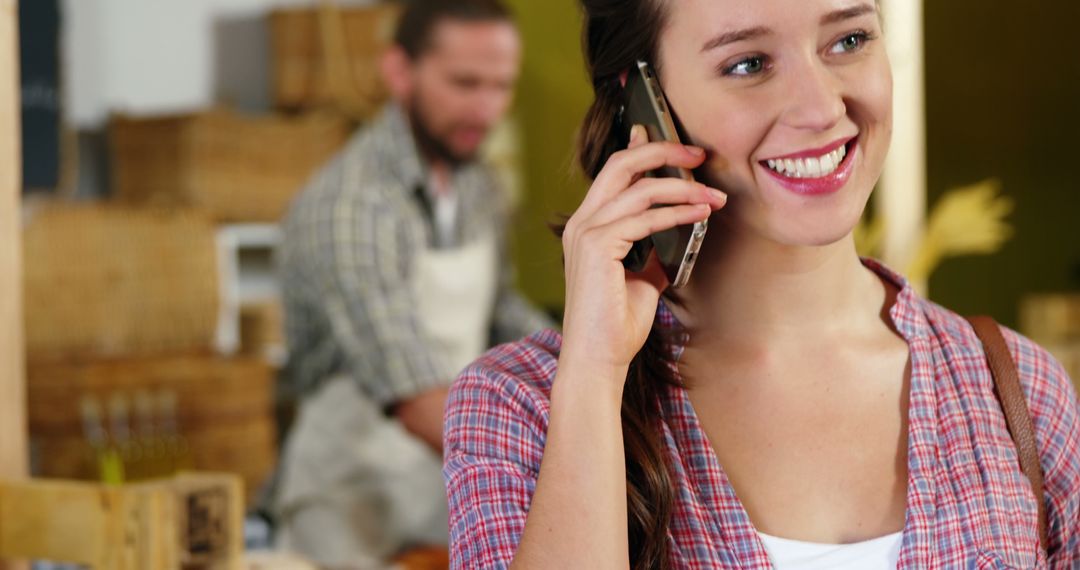 Woman Talking on Phone in Market Setting, Smiling - Free Images, Stock Photos and Pictures on Pikwizard.com