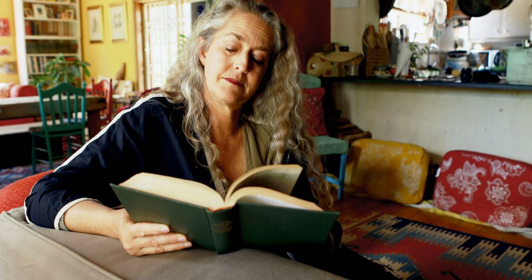 Elderly Woman Reading Book in Cozy Living Room - Free Images, Stock Photos and Pictures on Pikwizard.com