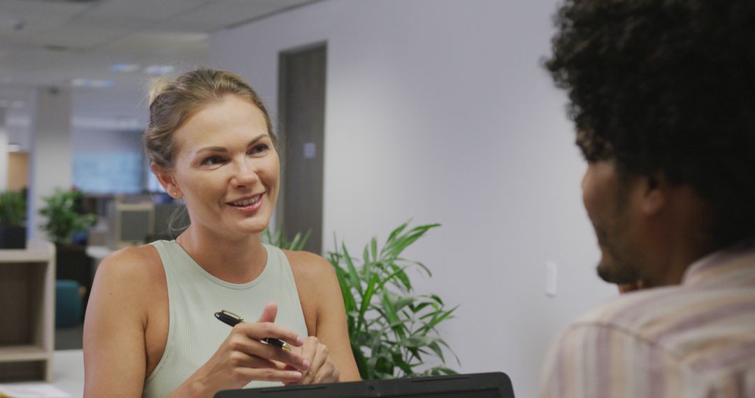 Diverse Colleagues Engaged in Office Discussion with Smiles
